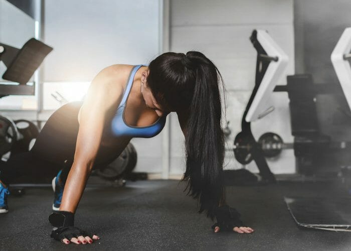 Woman doing pushups for cardio and arm training