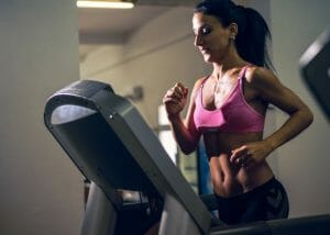 Woman running on treadmill at the gym