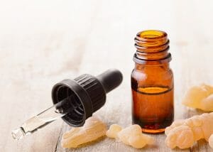 Frankincense essential oil bottle and pipette dropper for sagging skin