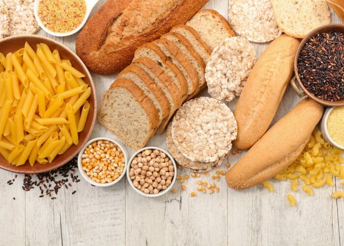 gluten free foods such as gluten free pasta, breads, and whole grains on a table