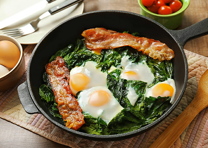 Keto bacon spinach and eggs in a pan