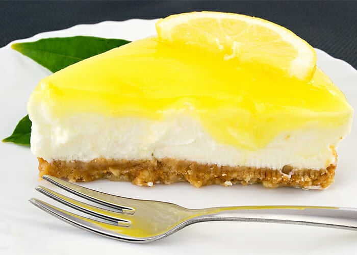 Slice of lemon and ginger Paleo cheesecake made from a homemade recipe