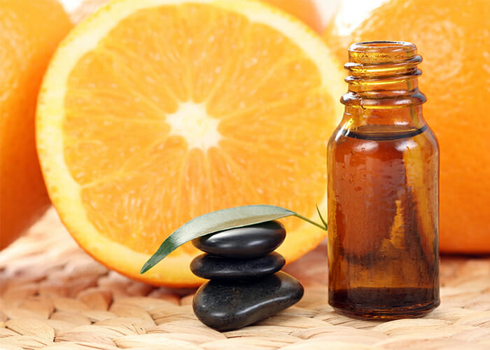 A closeup of a full vial of orange essential oil