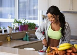 a fit woman prepping her meal in a kitchen