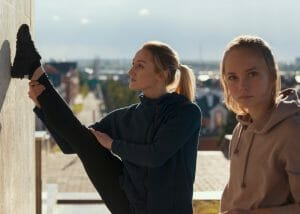 parkour women stretching on a rooftop