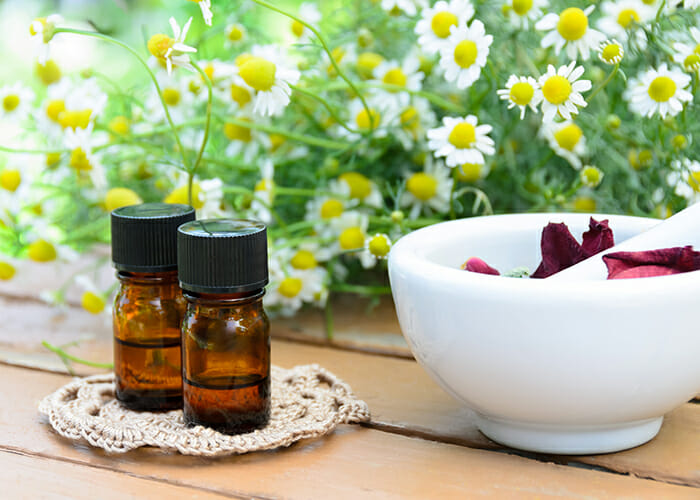 Bottles of rose and chamomile essential oil blend for combating anxiety