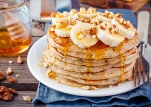 gluten free pancakes topped with bananas and sorghum syrup