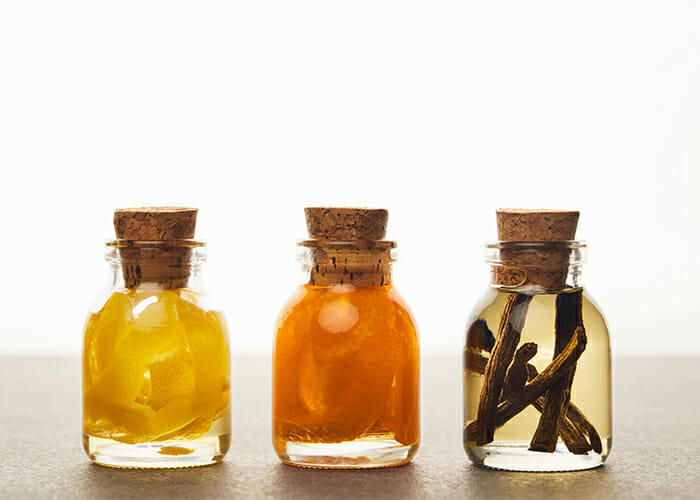 Vanilla, lemon, and orange essential oils blends in bottles