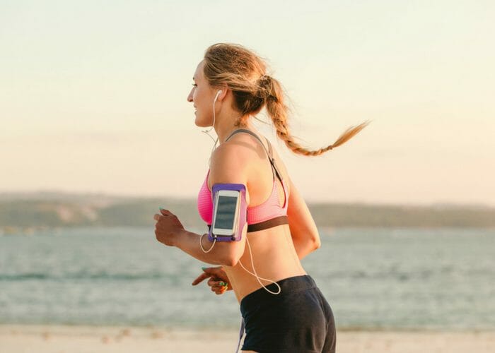 woman jogging outdoors by the beach