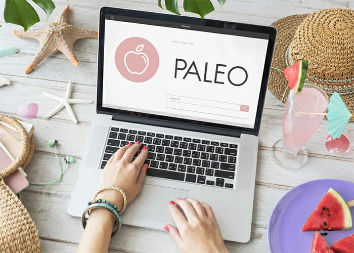 Woman searching for paleo diet meal plans on her computer