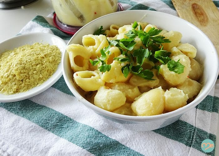 Dairy-free mac and cheese in a white bowl topped with parsley