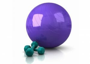 purple exercise ball office chair next to green dumbbells 