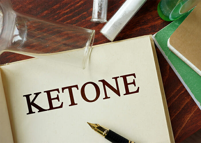 A book open to its title page with "Ketone" printed on it