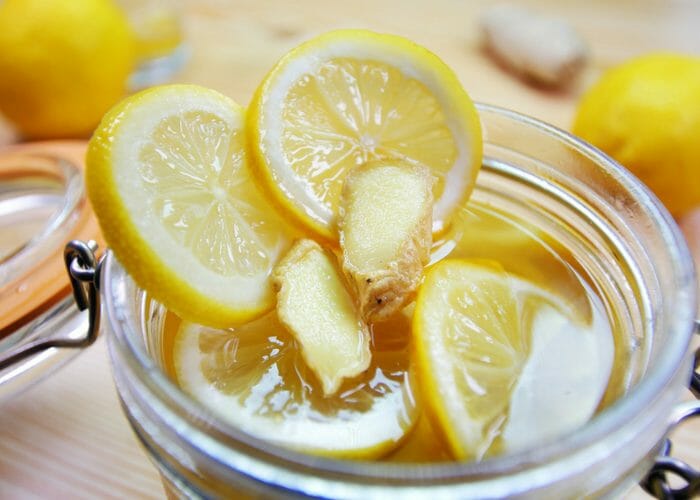 close up of lemon, honey and ginger mixture in mason jar