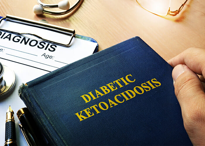 A doctor holding a book entitled "Diabetic ketoacidosis"