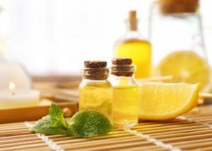 A spa composition of lemon essential oil bottles and fresh slices of lemon