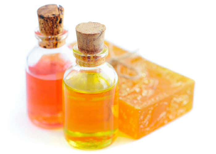 Two bottles of DIY essential oil blends and a handmade soap for men in Sultry Citrus scent
