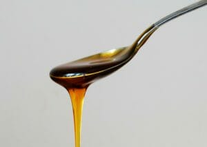 honey dripping down a silver spoon