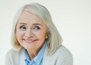 Elderly woman with glowing skin smiling