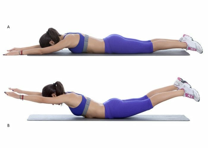Woman demonstrating how to do the superman lower back exercise in two steps