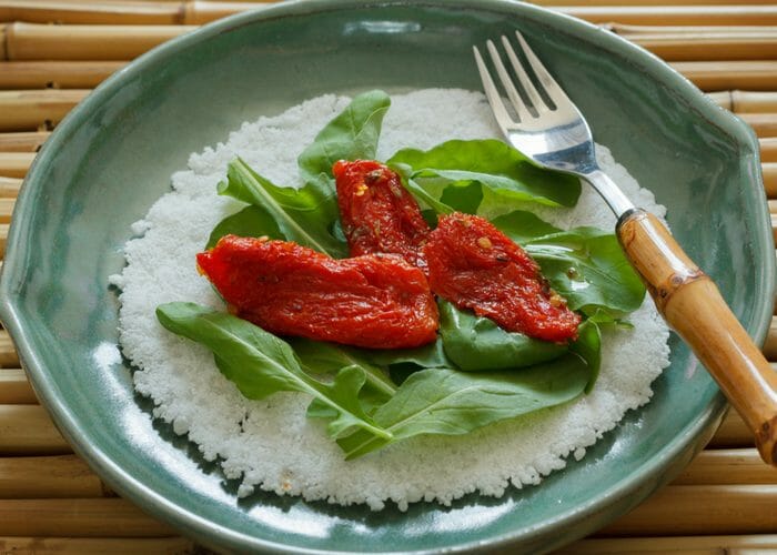 plate of cassava flour topped with spinach and roasted peppers